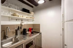 a kitchen with a sink and a counter top at Sweety home in center of Paris in Paris