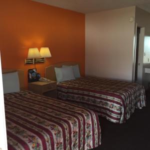 Postel nebo postele na pokoji v ubytování Avalon Motel