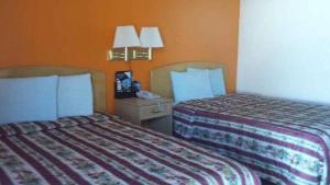 Postel nebo postele na pokoji v ubytování Avalon Motel