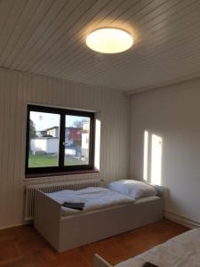 a bedroom with a bed in a room with a window at Arbeiterquartier in Lebring