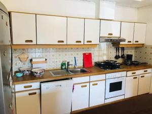 a kitchen with white cabinets and a sink at Arbeiterquartier in Lebring