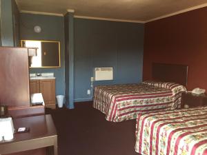 Postel nebo postele na pokoji v ubytování Avalon Motel