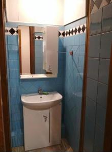 a bathroom with a sink and a mirror at улица Абазгаа Апартаменты in Gagra
