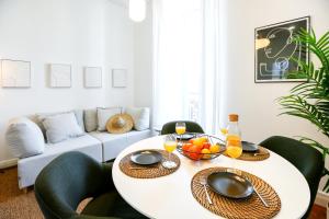 a living room with a white table and chairs at Offline Mood Apartment in Faro