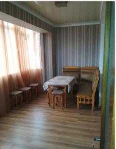 a room with a table and chairs and a table and chairs at улица Абазгаа Апартаменты in Gagra