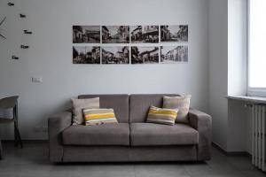 a living room with a gray couch with two pillows at Casa Alessia Appartamento Confortevole in Gassino Torinese