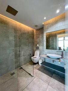 a bathroom with a toilet and a sink and a shower at City View Apartment Nestled in the Heart of NBO in Nairobi