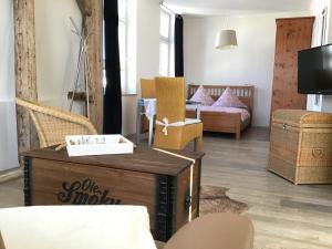 a living room with a table and chairs at Appartementhaus Warnemünde in Warnemünde