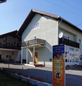 a building with a sign in front of it at Apartman OPG Balja in Garešnica