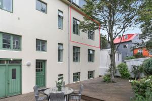 a patio with a table and chairs in front of a building at Cosy apartment in the old west Reykjavik center in Reykjavík