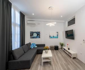 a living room with a couch and a table at Central Suites Aegina 2 in Aegina Town