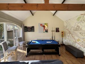 a living room with a pool table in it at Creamery Cottage in York