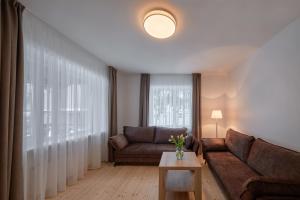 a living room with a couch and a table at Jonavos alpakų svečių namai in Jonava