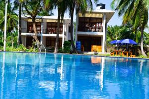 a large swimming pool in front of a building at High Park Hotel in Nilaveli