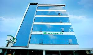 a tall blue building with the words h korean green me at Hotel Greenlife in Cochin