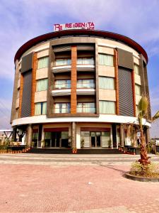 a hotel building with a sign on top of it at Regenta Place Mohali in Mohali