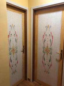 two doors with embroidery on them in a room at La Casa nella Pineta in Fiuggi