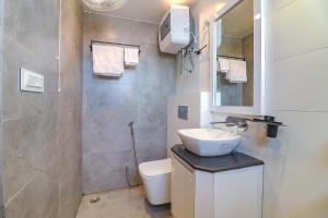 a small bathroom with a sink and a toilet at FabHotel Grand Arya in Patna