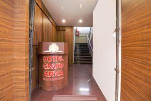 a hallway with a hotel grand avenue sign and stairs at FabHotel Grand Arya in Patna