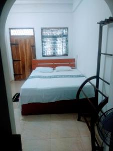Katil atau katil-katil dalam bilik di Sigiriya Guest House Inamaluwa