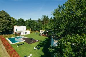 an aerial view of a house with a swimming pool at Quinta do Pomar Maior in Arouca