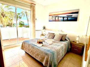a bedroom with a bed with a view of the ocean at Sitges Seafront Ribera Apartment in Sitges