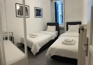 Cette chambre comprend 2 lits et un miroir. dans l'établissement Art in Athens Suite, à Athènes