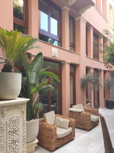 a courtyard with chairs and plants in a building at Farmaki Residence, Plaka in Athens
