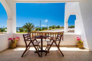 a table and chairs on a balcony with a view at Konstantinos in Adamantas