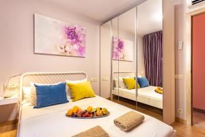 a bedroom with a bed with a plate of fruit on it at Three bedrooms apartment in Barcelona