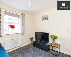 a living room with a flat screen tv next to a window at 4 Bed Monthly Discount Family Contractors Business By Fobis Suites Short Lets & Serviced Accommodation Hatfield in Hatfield