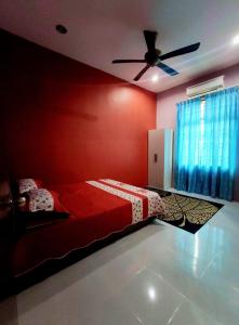 a bedroom with a bed and a ceiling fan at Villa Mikayla Homestay - Alor Setar in Alor Setar