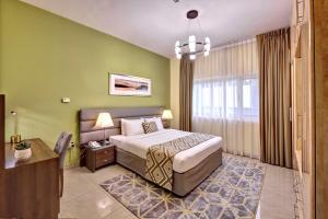 a bedroom with a bed and a desk in a room at Radiance Premium Suites in Dubai