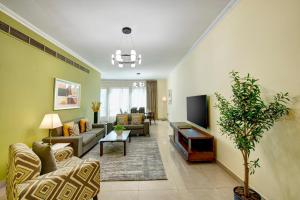 a living room with two couches and a tv at Radiance Premium Suites in Dubai