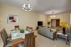 a living room with a dining table and a couch at Radiance Premium Suites in Dubai