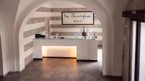 a room with an archway with a table in it at Hotel La Smorfia in Castiglioncello +14 photos