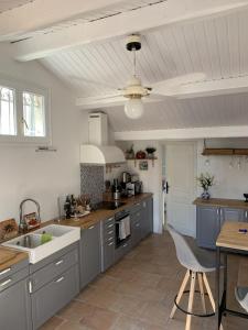 a kitchen with gray cabinets and a white ceiling at Villa Acacia in Vallauris