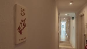 a sign on a wall in a hallway at Hotel La Smorfia in Castiglioncello