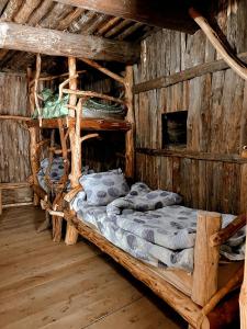 a room with two beds in a log cabin at Ethnic Hostel Shatili in Shatili