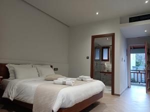 a bedroom with a large bed with towels on it at The Flower Of Monemvasia Hotel in Monemvasia