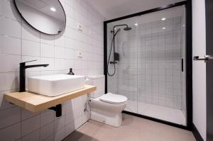 a bathroom with a sink and a toilet and a shower at Hotel Rural O Cruce do Burgo in Friol