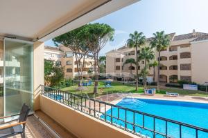 a balcony with a view of a pool and buildings at Hacienda Playa in Marbella