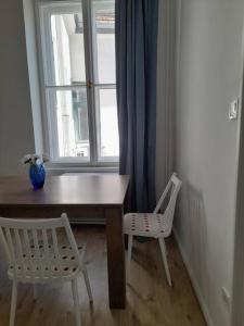 a table and two chairs in front of a window at Sunny rooms at Danube in Budapest