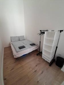 a small room with a bed and a shelf at Sunny rooms at Danube in Budapest