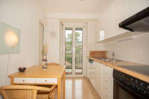 a kitchen with a table and a counter top at Spacious apartment next to park with free BaselCard in Basel