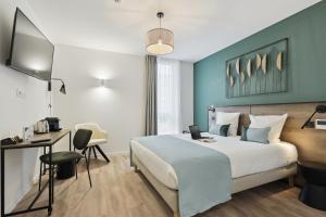 Pokój hotelowy z łóżkiem i biurkiem w obiekcie All Suites Noisy Le Grand w mieście Noisy-le-Grand