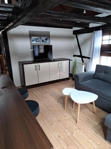 a living room with a couch and a table at Ferienwohnung Gesindestube in Brotterode-Trusetal