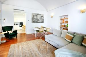 a living room with a couch and a table at Coast Guard Apartment in Faro