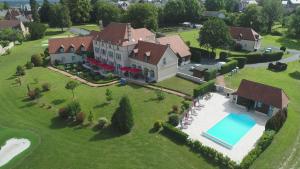 uma vista aérea de uma grande casa com piscina em Hôtel et Restaurant Domaine de l'Orangerie em Bonnat