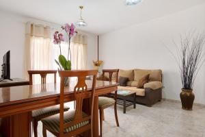 a living room with a table and a couch at Casa Rosi in Gran Tarajal